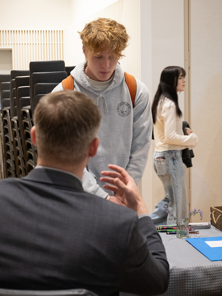 Student and employer speaking at internship fair