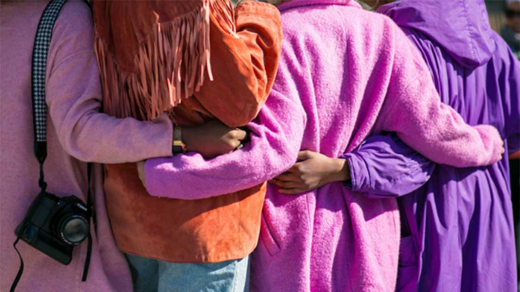 A group of people arm in arm