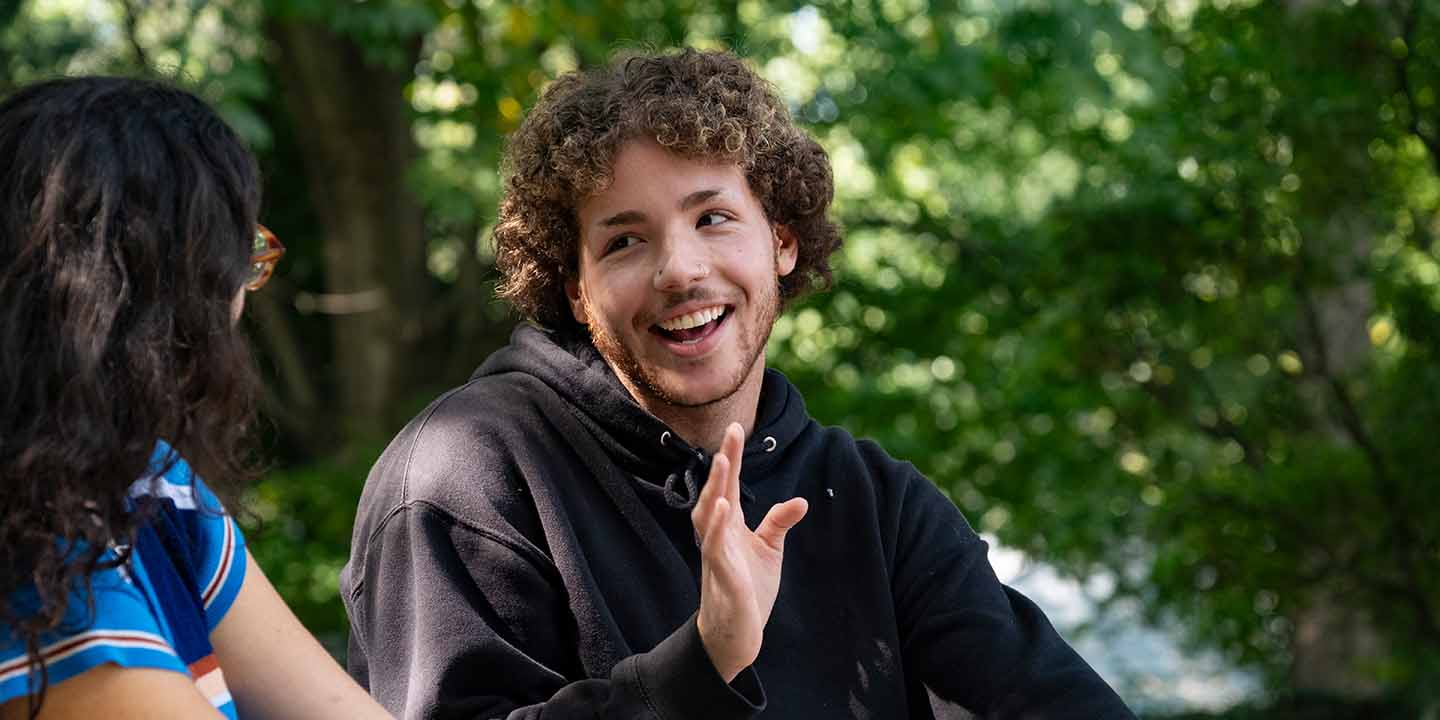 portrait of a student smiling in conversation