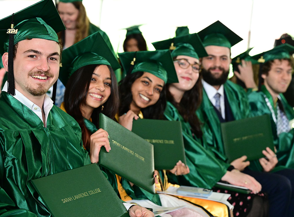 Student smiling in caps and gowns
